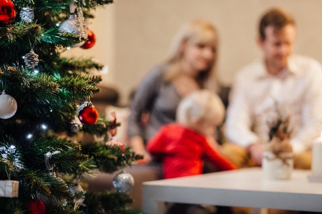 family behind a Christmas tree