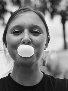 Woman blowing a bubble 