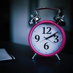 An alarm clock on a nightstand.