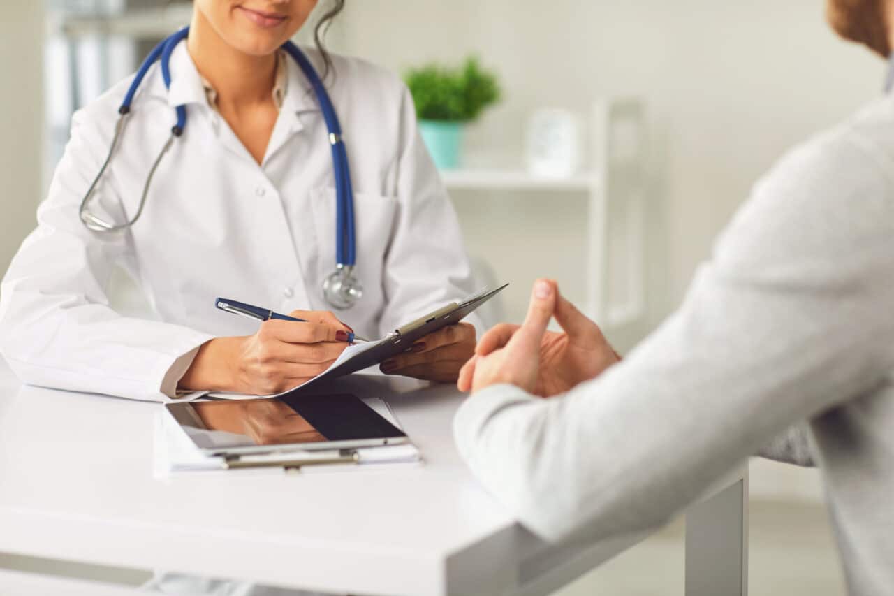 A doctor speaks with a patient about a procedure.