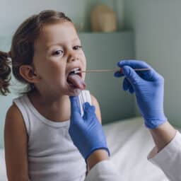 Young girl getting a throat swab